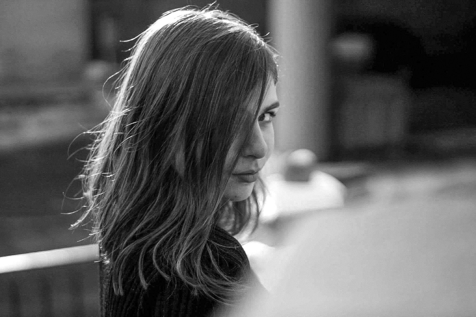 A striking black and white portrait capturing a woman's contemplative gaze.